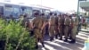 Turkmenistan -- Soldiers on the bus stop. People. Line. Turkmenabat. July 16, 2014